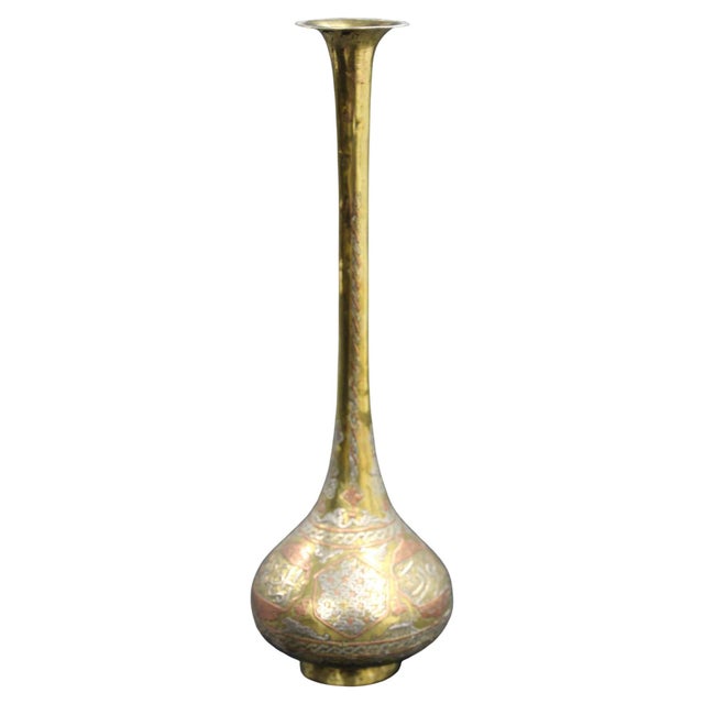 An exceptionally decorative late 19th-century Islamic brass vase, distinguished by its elegant elongated silhouette,...