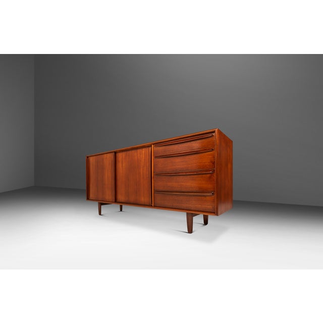 This exceptional 1960s Danish modern teak credenza by Svend Age Madsen for Falster Mobelfabrik exemplifies the refined...