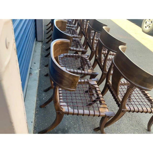 Klismos solid walnut dining chairs. The ROBSJOHN Gibbings style chairs are made of solid walnut with a satin finish and...