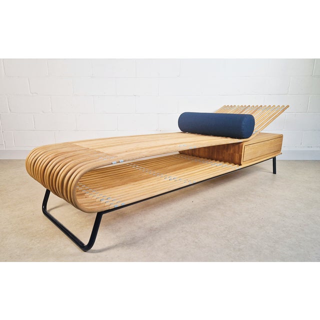 This stunning daybed showcases exceptional Danish design with a sleek construction of solid curved ash and a powdered...