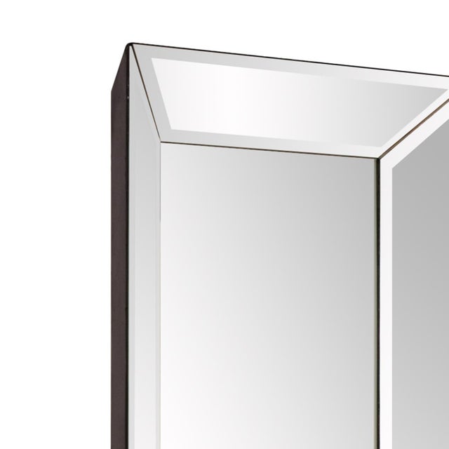 This striking piece features rectangular mirrored frame that is pitched, flaring away from the wall. Each mirrored section...