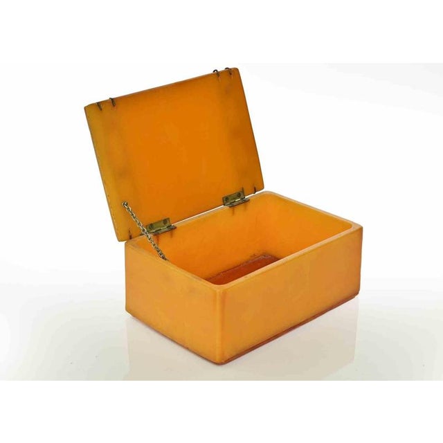 Vintage marbelized butterscotch box by Minerva. Hinged lid with inset pink jewels. Minor signs of age.