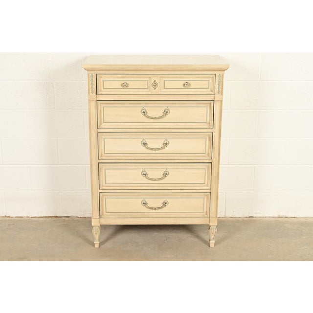 A gorgeous French Regency Louis XVI style highboy dresser In the manner of John Widdicomb By Dixie USA, Circa 1960s Carved...