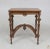 A graceful, if somewhat heavy, coffee table in walnut wood with high curved base arches in the style of Napoleon III....