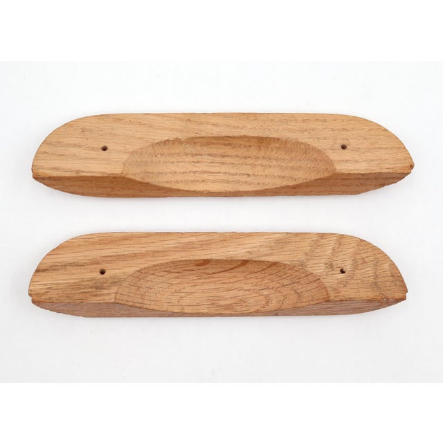 Vintage unfinished oak drawer pulls featuring a fan shaped scalloped shell carving. The original mounting screws are not...