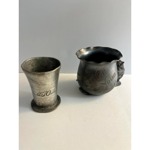 Antique small pot metal objects which could both be toothpick holders. One features a small bird and the other is engraved...