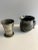 Antique small pot metal objects which could both be toothpick holders. One features a small bird and the other is engraved...