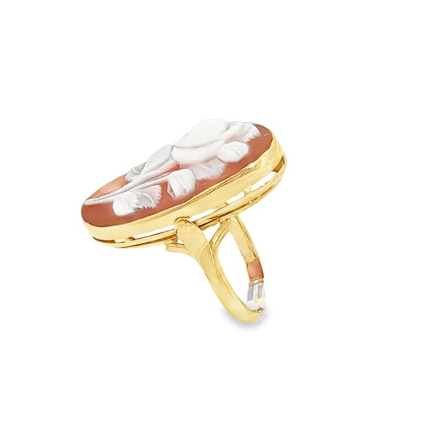 A mid-20th-century fashion ring. Crafted in 14k yellow gold. Features an oval shell cameo with a rose design. Total weight...