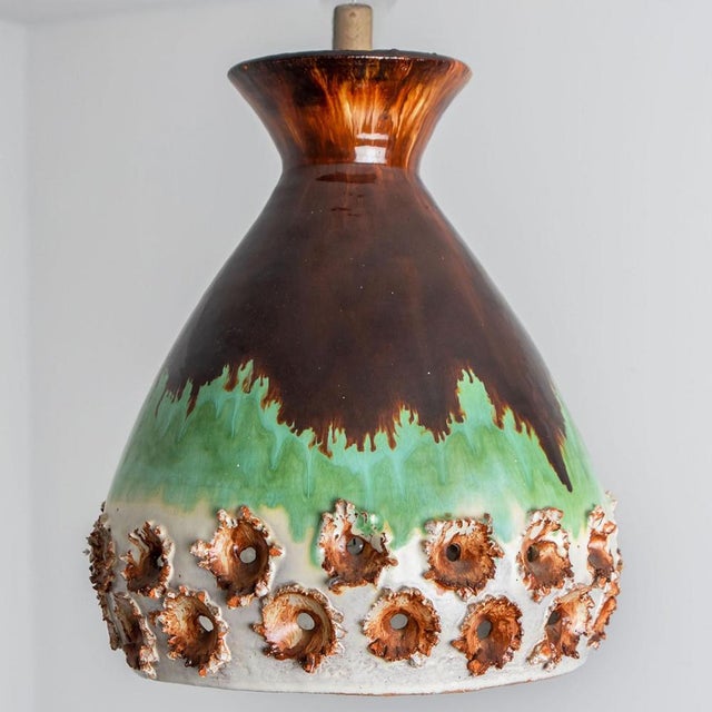 Stunning round hanging lamp with an unusual egg-like shape, made with rich colored green and brown ceramics, manufactured...