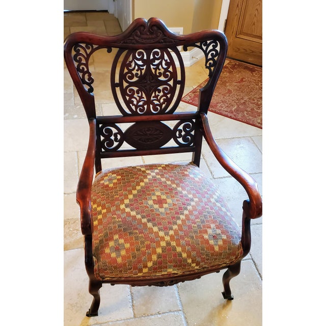 Beautiful, high-quality Chippendale-style ribbon-back armchair crafted from rich, carved mahogany. Features an intricately...