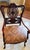 Beautiful, high-quality Chippendale-style ribbon-back armchair crafted from rich, carved mahogany. Features an intricately...
