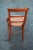 Vintage French Country cane seat chair. The wooden chair features a ladder back with arching side rails, and turned...
