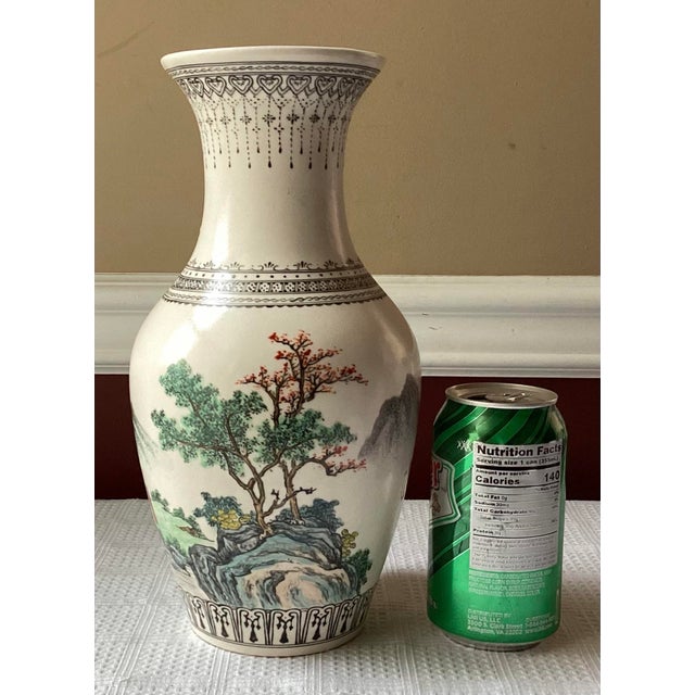 This elegant vintage Chinese porcelain vase stands 11 inches tall and features a beautifully detailed, hand-painted...