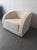 This Armani Casa lounge chair features a soft beige fabric and a sleek, modern design. Its curved back and wide seat offer...