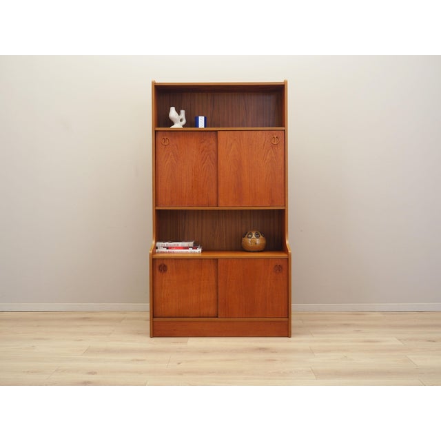 The bookcase was made in the 1960s, Danish production. The structure is covered with teak veneer. The piece is placed on a...