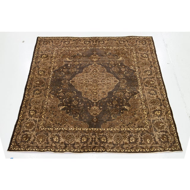 This vintage hand-knotted wool rug has a gray and brown field with beige accents all over the motif. This rug measures...