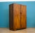 Italian Art Deco walnut wardrobe with striking bookmatched veneers, rounded corners and original curved handles, raised on...
