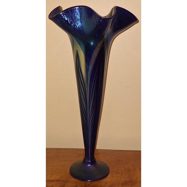 This 15 1/4h art glass blue vase is signed on the bottom American silver Glass v16. It is in fine condition.