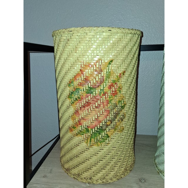 Set of two waste baskets from the 1950s with floral design. Brand is Harvey. They are in good vintage condition.