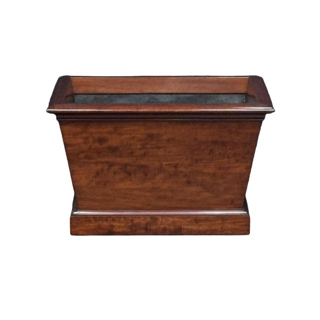 A fine English wine cooler (also known as a cellarette) for wine and spirits, crafted in a traditional sarcophagus form....