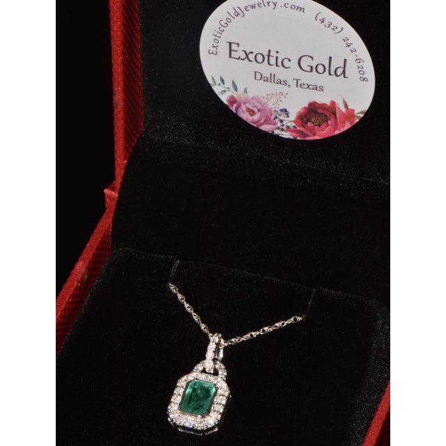 Gorgeous certified natural emerald and diamond halo pendant crafted in solid 18K white gold. This pendant features a...