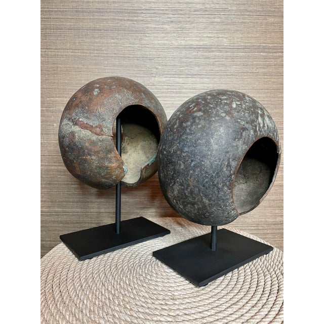 A pair of copper forms from the Mbole people of Central Africa. Displayed on custom metal stands, these pieces have a...