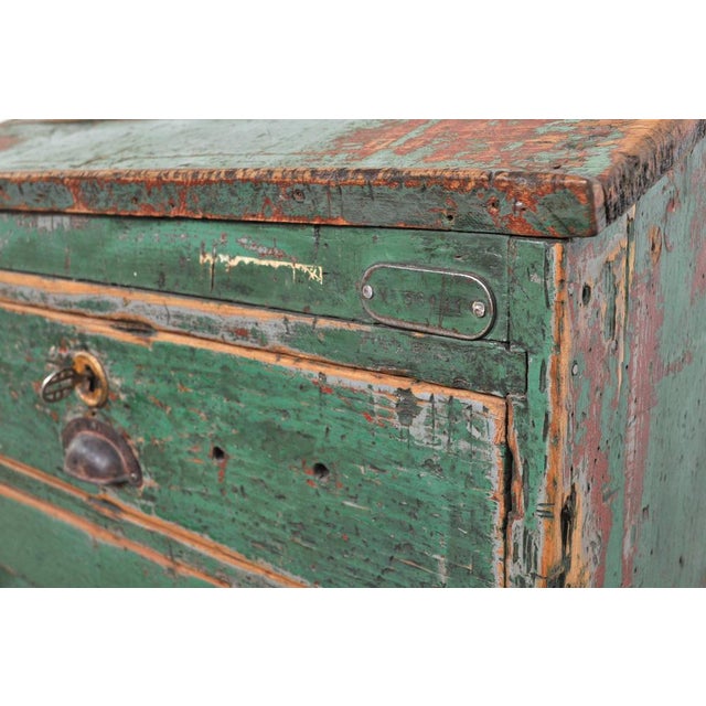 The sloping top probably served as a kind of note table in the factory. Also looks a bit like a lectern. Thanks to the...