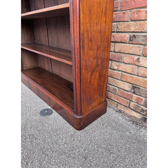 Victorian open bookcase in mahogany, having mahogany sides and top with moulded edge above two height adjustable shelves a...