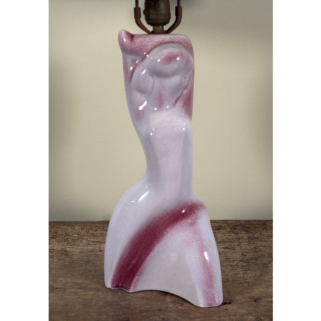 This ceramic table lamp by Yasha Heifetz features an abstract female nude form in a glossy glaze with purple and white...