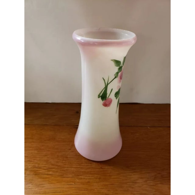 This is a Vintage Milk Glass Rose Motif Flower Vase. It measures 8 1/2" high and 3 1/4“ in diameter at the rim. The piece...