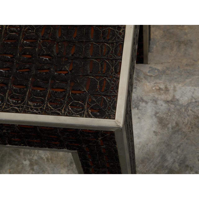 An Italian vintage faux alligator side table from the mid 20th century with metal accents. Created in Italy during the...