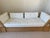 Natural wicker, rattan frame couch with white cushions from The McGuire Company, c. 1970. The white leather cushions are...