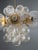This elegant mid-century chandelier originates from Europe and dates to the 1960s. It features a refined brass...