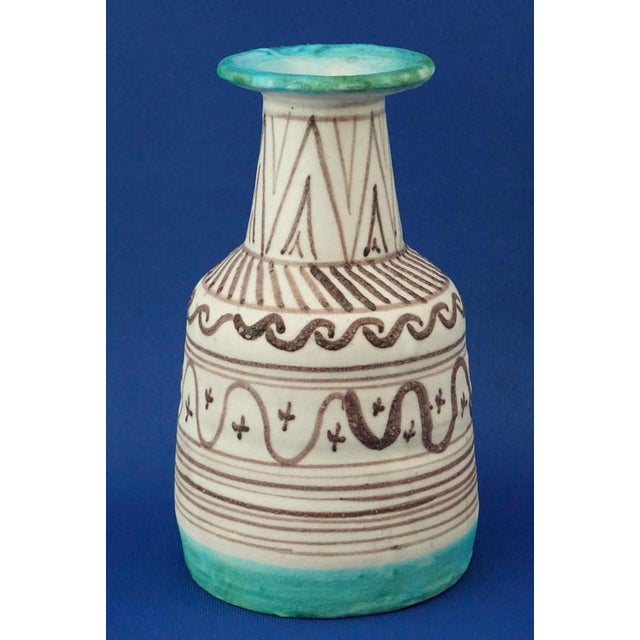 Description of the item: ceramic vase, vaguely bottle-shaped, hand-modeled on a potter's wheel and then glazed and...