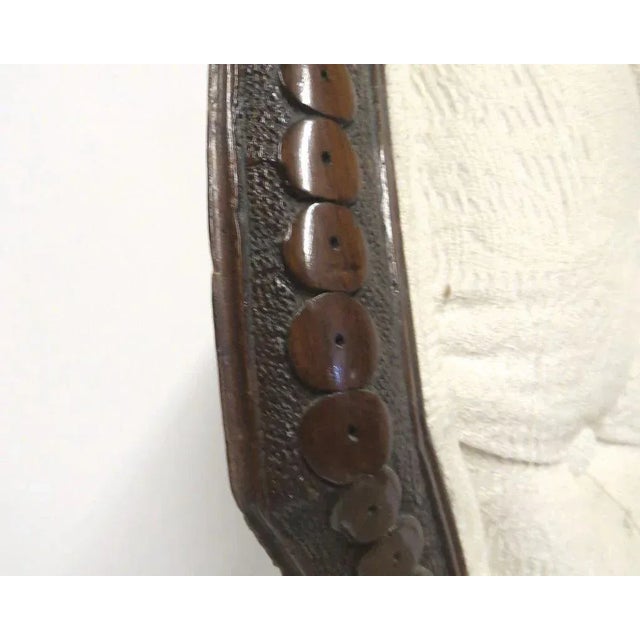 Walnut open armchair. Carved frame with leaf carved cabriole legs with scroll toe and original casters. Upholstered tufted...