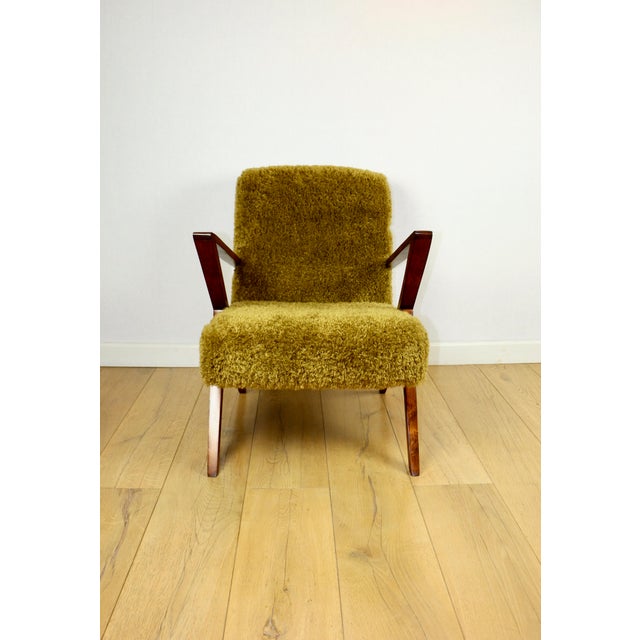 Vintage loft armchair in khaki/olive colour with long hair, fox style. Renewed armchair. A vintage 1970s armchair...