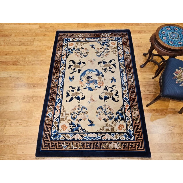 This vintage Chinese Art Deco area rug is a beautifully woven tapestry of symbolism, elegance, and cultural heritage....