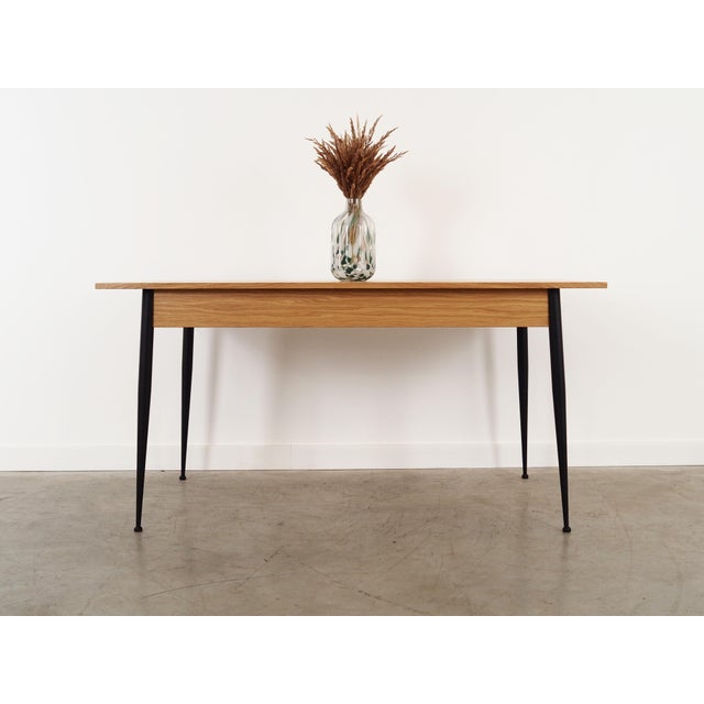 The table was made in the 1980s, Italian production. The structure and the table top are covered with oak veneer. The legs...