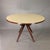 Elegant Italian-designed round table in the style of Osvaldo Borsani, 1950s. Crossed compass legs in mahogany-colored...