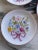 Here is a darling vintage set of four miniature 3.75" plates featuring a spring and summer floral nosegay tied with a pink...