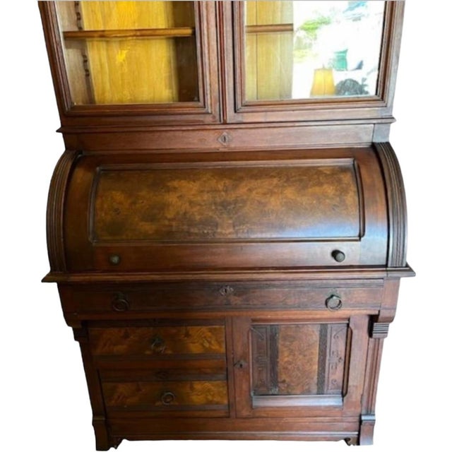 This desk is sure to impress with its antique charm. The roll top and bookcase provide ample storage space for all your...