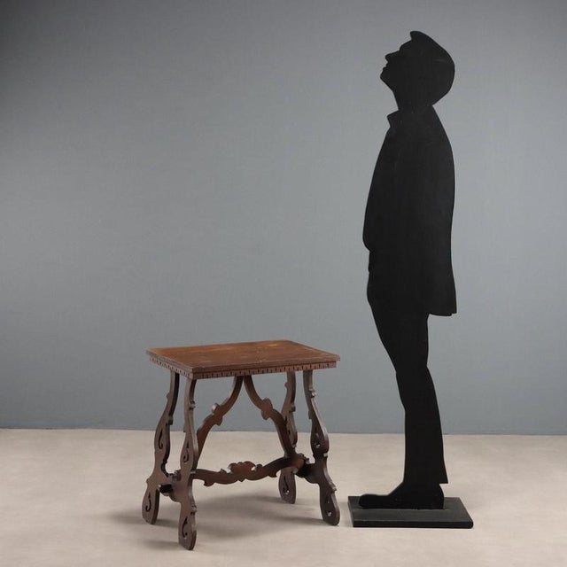 Walnut coffee table, refectory style. Perforated legs joined by a crosspiece and buttresses. Italy, first half of the 20th...