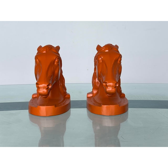This is a lovely pair of orange lacquered metal bookends Dimensions: 5" Width x 3.5"Dept x 6"Height See pictures and...