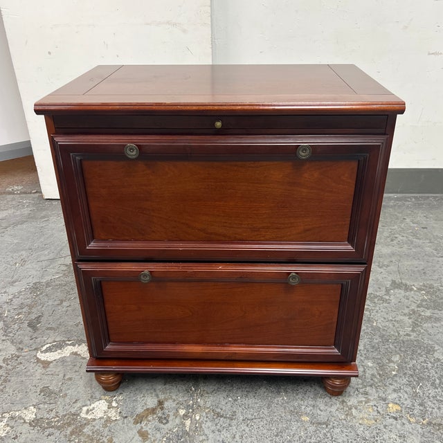 Design Plus Gallery presents a Lateral Filing Cabinet from The Bombay Company. It offers two full width, stacked drawer...