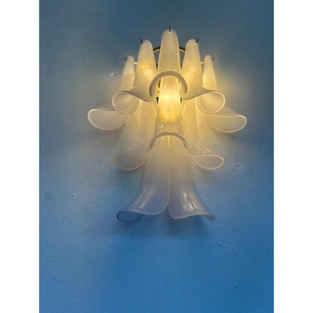 Luxury and and elegant frosted “selle” wall sconce transparent frosted “selle” elements in murano glass poured over a mold...