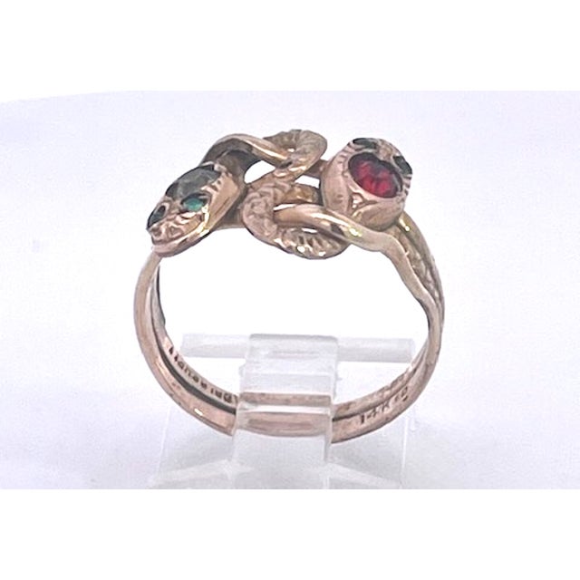 This Captivating antique Double Snake ring is crafted in 14K Yellow Gold, featuring two intertwined Serpents coiled...