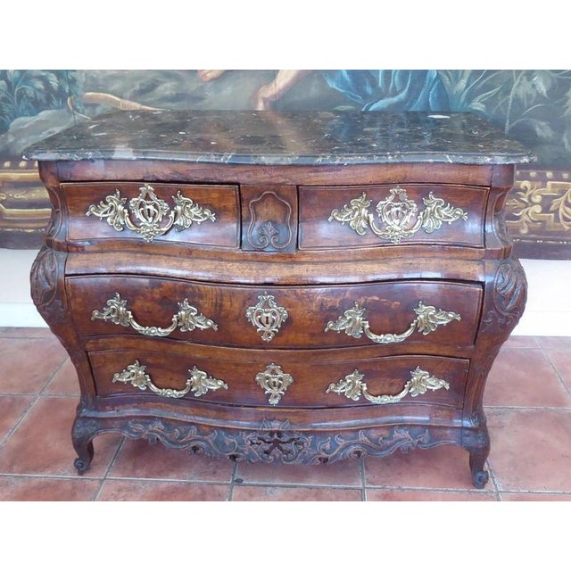 A substantial early 18th-century bombé chest of drawers, dating from circa 1730–1740 and constructed from walnut with a...