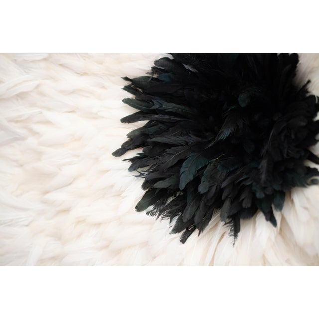 Large African Juju hat made of ivory/off white chicken feathers, bamboo, and rafia with a black feather center. 31x31x6