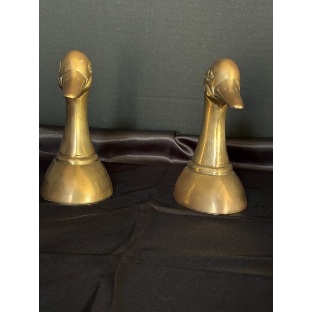 Add a touch of classic MCM charm to your bookshelf with this stunning pair of vintage solid brass mallard duck head...