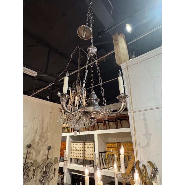 The Vintage English Nickel Plated 3-light Chandelier is a classic and handsome lighting fixture perfect for adding a touch...